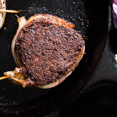 Bacon wrapped Choffy crusted filet mignon on a plate