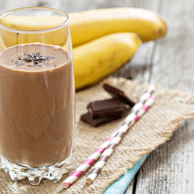 A chocolate banana Choffy protein smoothie in a glass
