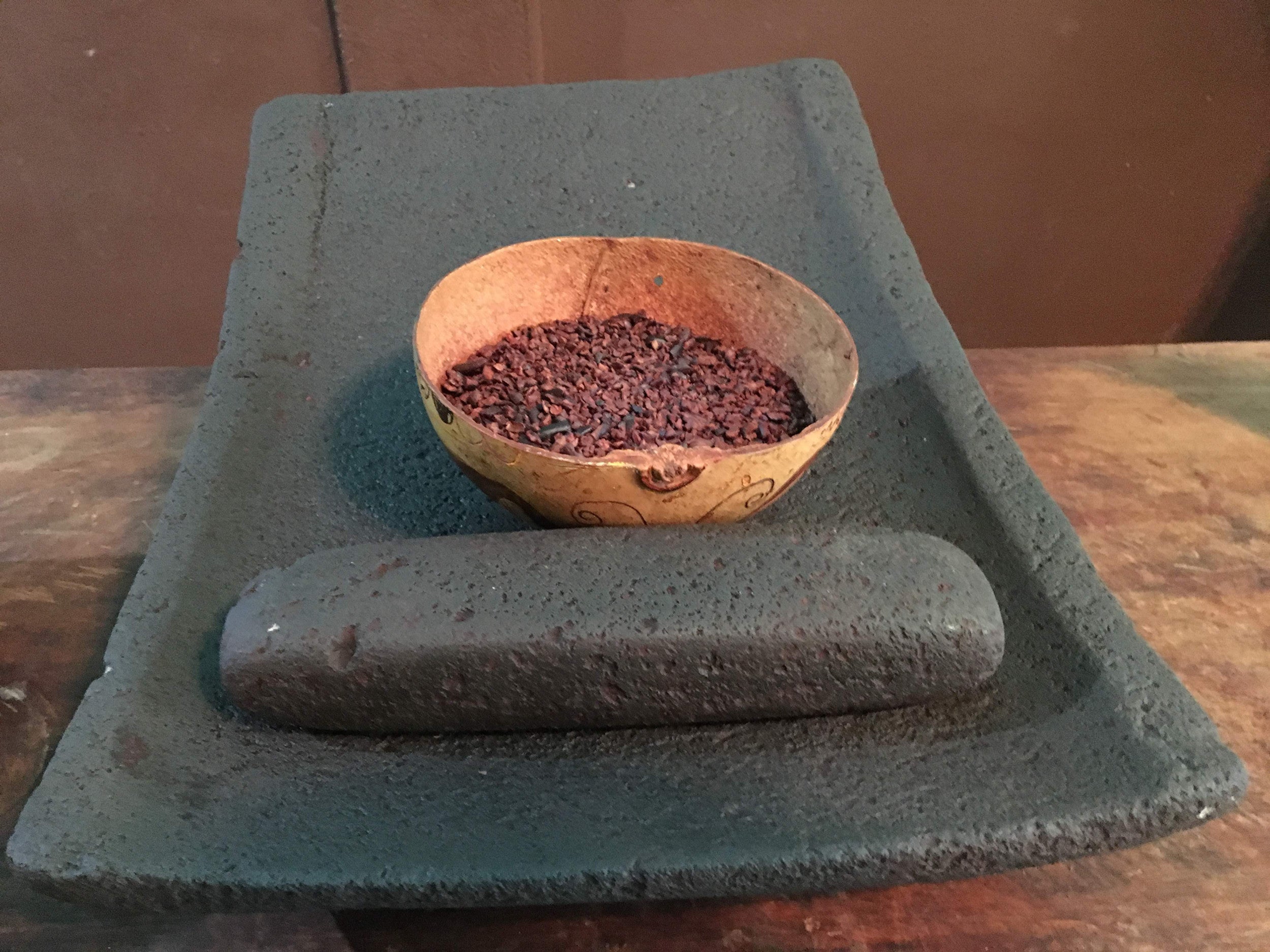 Cacao beans being prepared on a traditional Mayan cookset